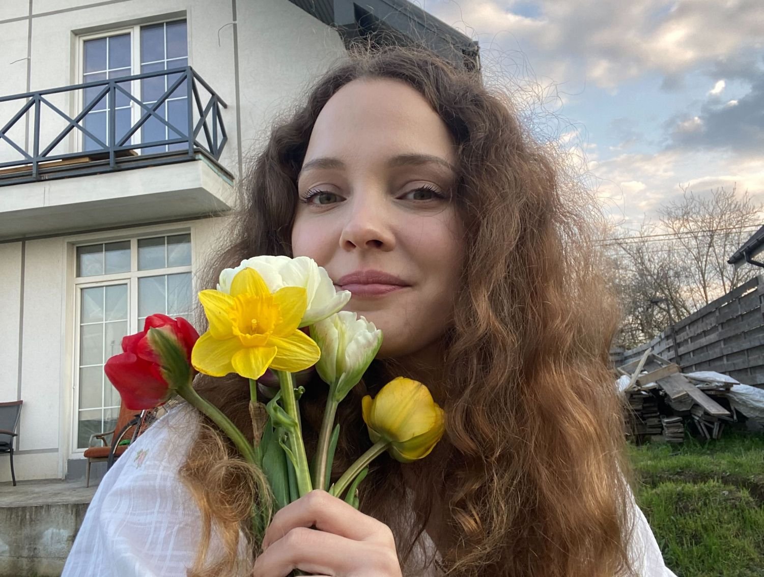 Daria at her home with flowers from her own garden.